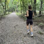 Woman jogging on forest trail
