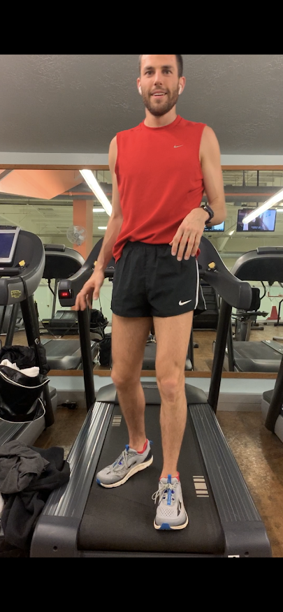 Person running on a treadmill indoors.