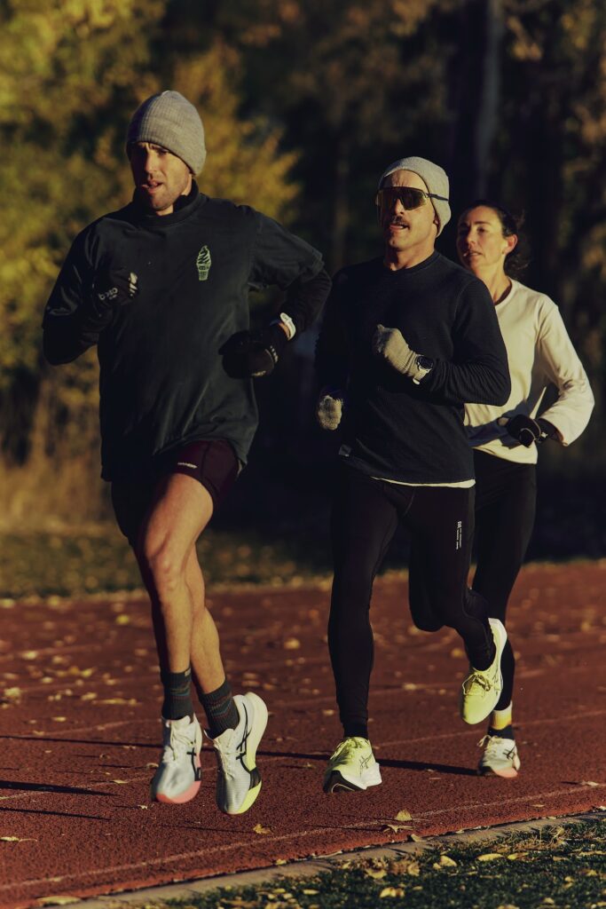 Three runners training on a track.