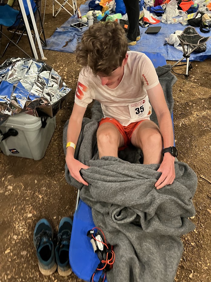 Runner resting with blanket on ground
