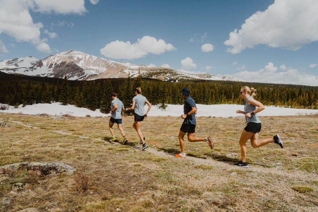 Group running in mountainous landscape.